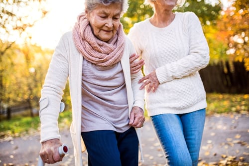 Woman walking with elderly mom